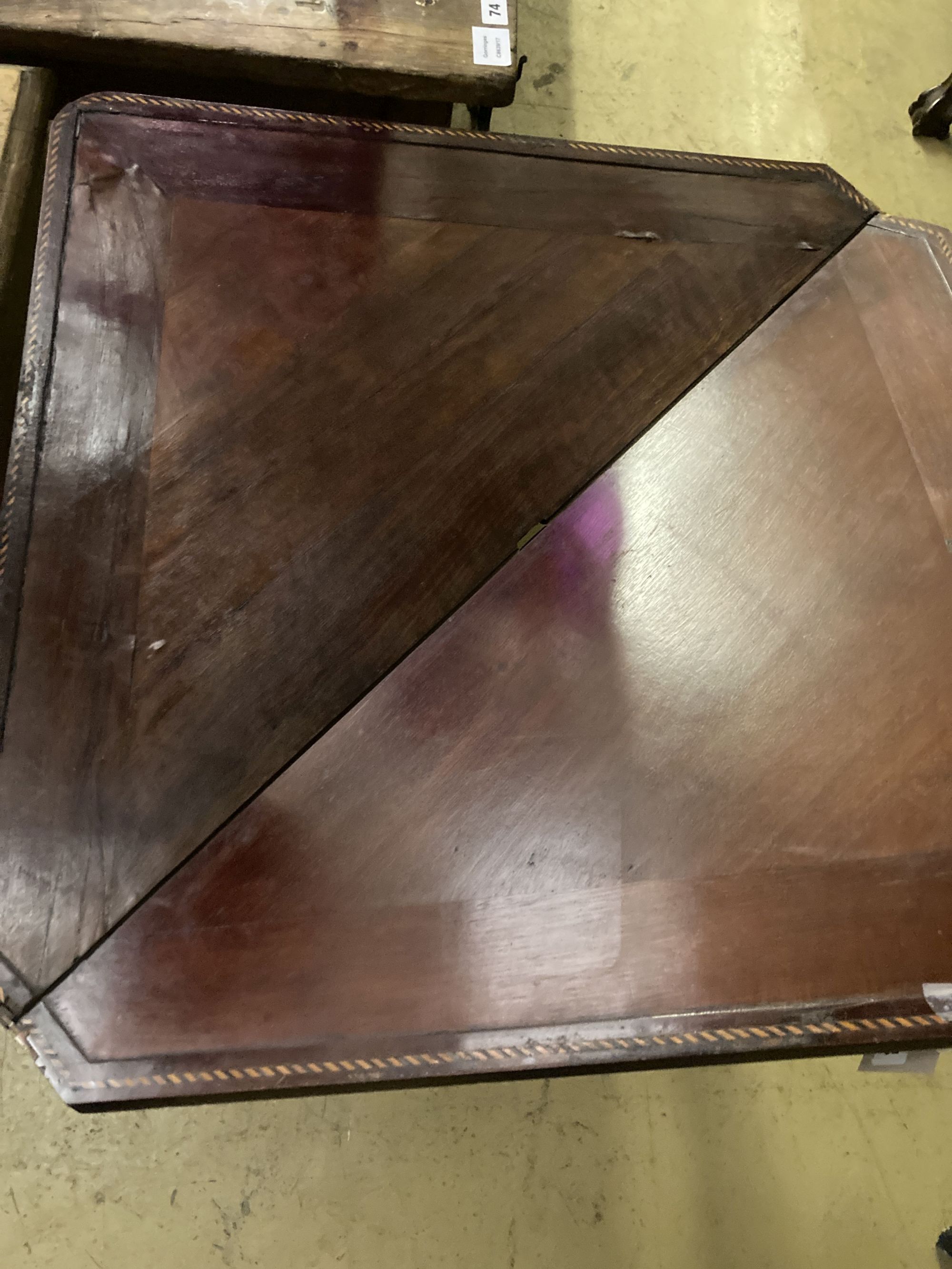 An early 19th century Dutch marquetry inlaid walnut triangular folding tea table, width 93cm, depth 51cm, height 76cm